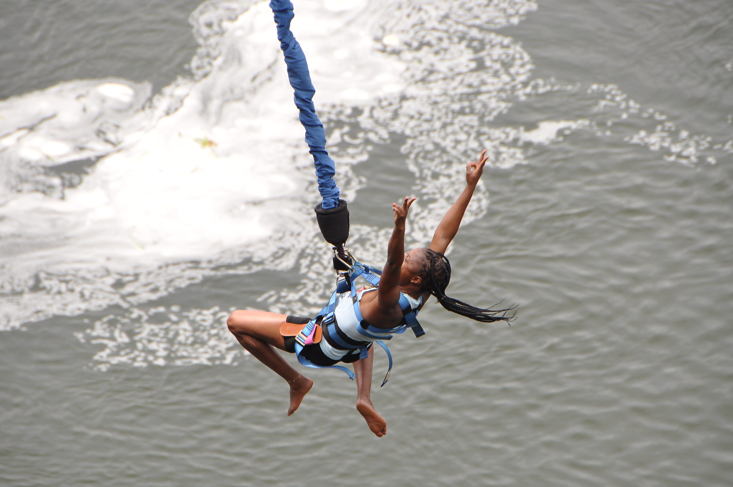 A girl bungee jumping into river Nile in Bungee Uganda